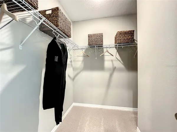 a spacious bathroom with a shower a sink and mirror