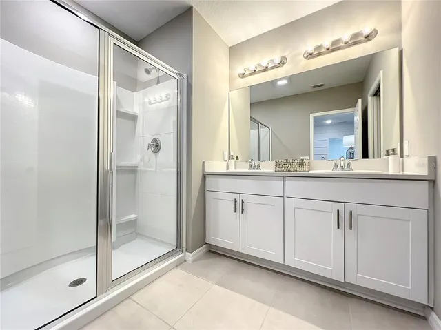 a bathroom with a double vanity sink and a mirror