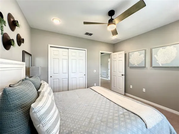 a bedroom with a large bed and a large mirror