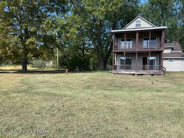 a view of a tree with a yard