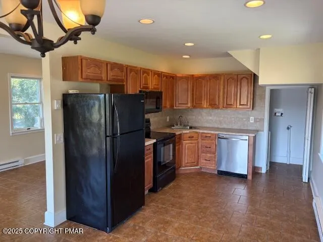 a kitchen with stainless steel appliances granite countertop a refrigerator a sink and a stove
