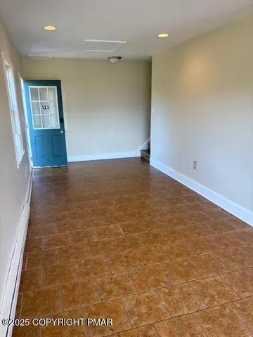 a view of an empty room with a window