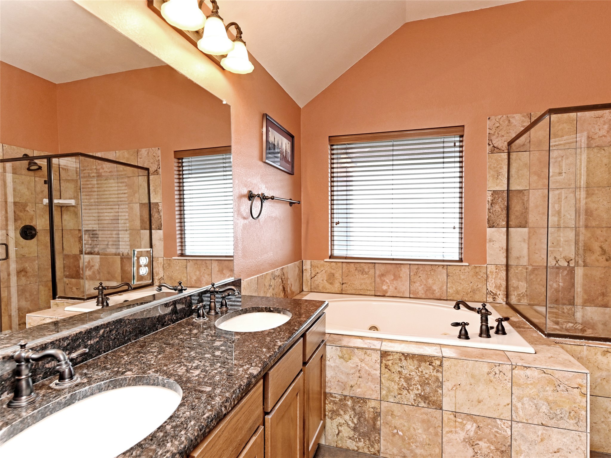 230 Sunrise Ridge Loop Austin, TX 78738 - Photo 19 of 27 Dual vanities with granite counters provide ample space in this tiled bathroom.