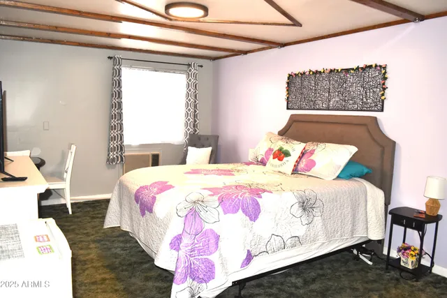 a bedroom with a bed and a night stand