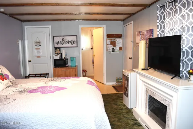 a bedroom with a bed and a flat screen tv