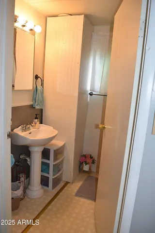 a bathroom with a sink and mirror