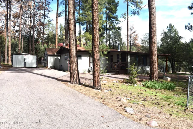a view of a bench in the backyard of house