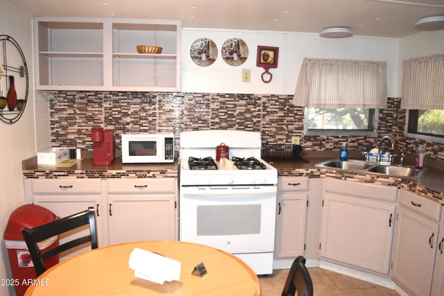a kitchen with a stove a sink and a refrigerator