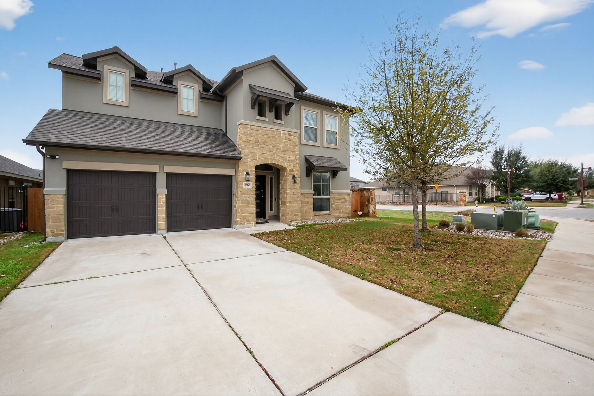 400 Cortona Lane Georgetown, TX 78628 - Photo 2 of 40 Traditional-style home with stone siding, driveway, stucco siding, and a shingled roof