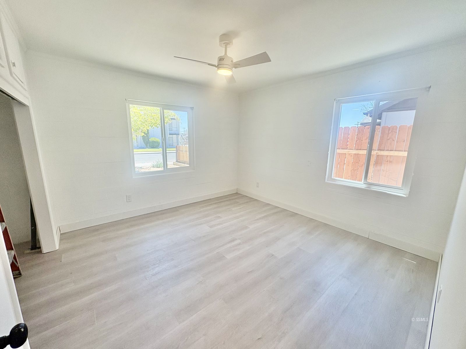 729 North Sanders Street Ridgecrest, CA 93555 - Photo 10 of 17 a view of an empty room with wooden floor and a window