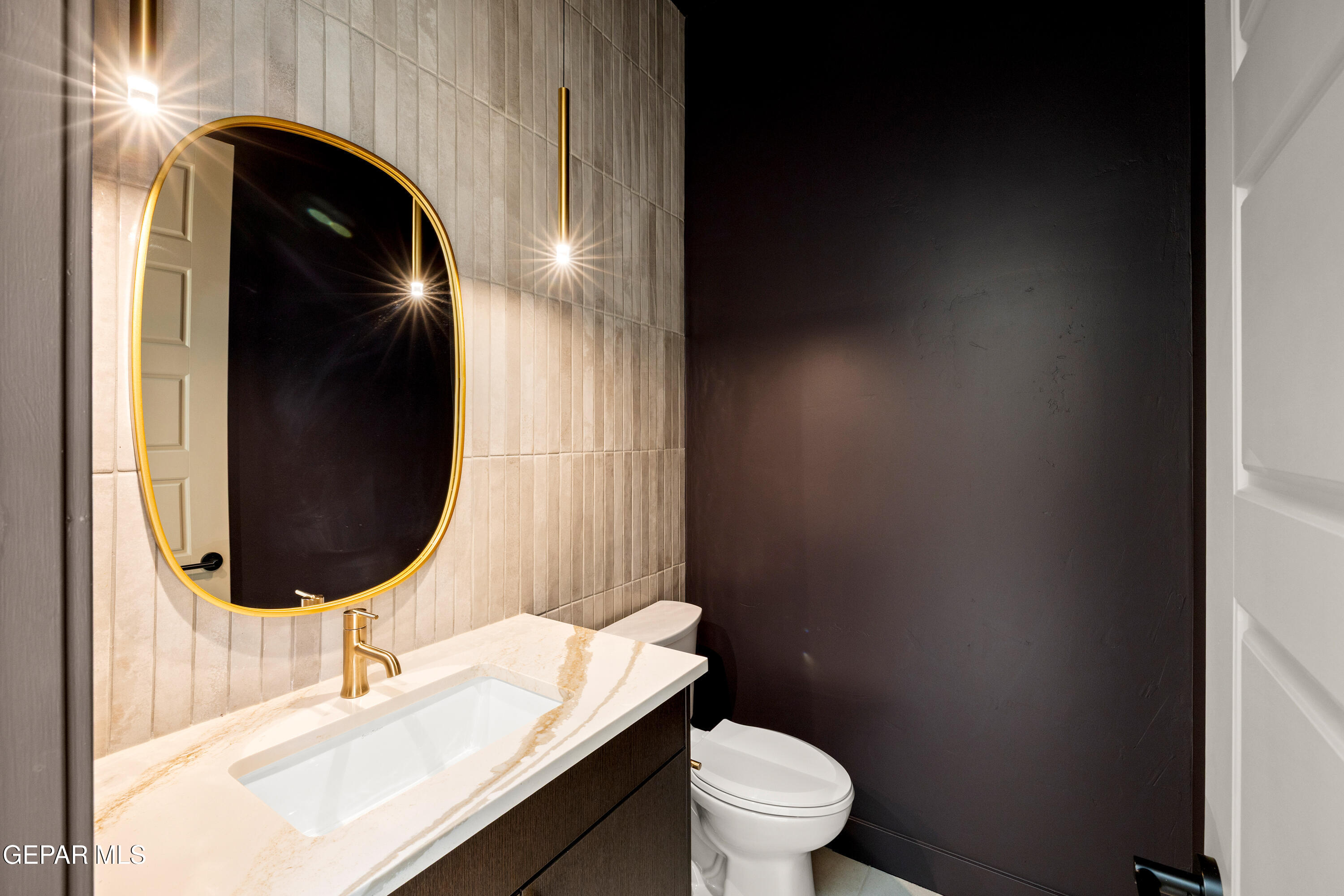 7280 Cimarron Rim Drive El Paso, TX 79911 - Photo 8 of 8 a bathroom with a toilet mirror and vanity