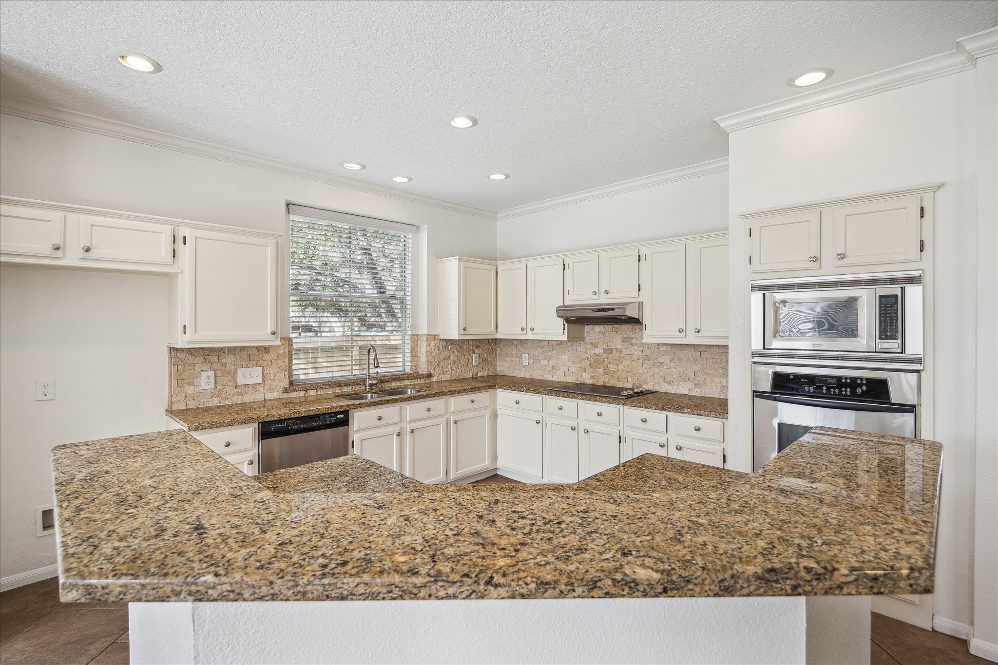 12831 Dove Point Lane Houston, TX 77041 - Photo 23 of 49 a kitchen with stainless steel appliances granite countertop a sink stove and refrigerator