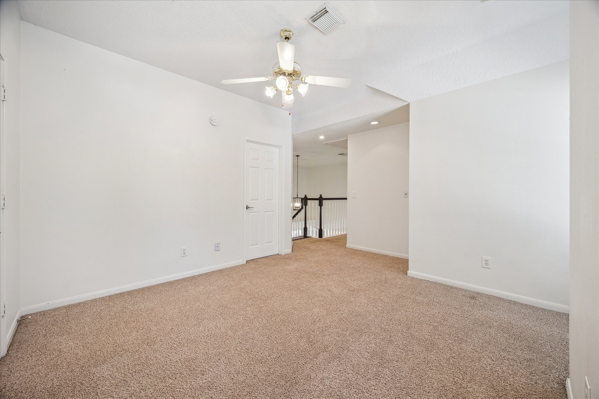 12831 Dove Point Lane Houston, TX 77041 - Photo 42 of 49 an empty room with a chandelier fan and closet