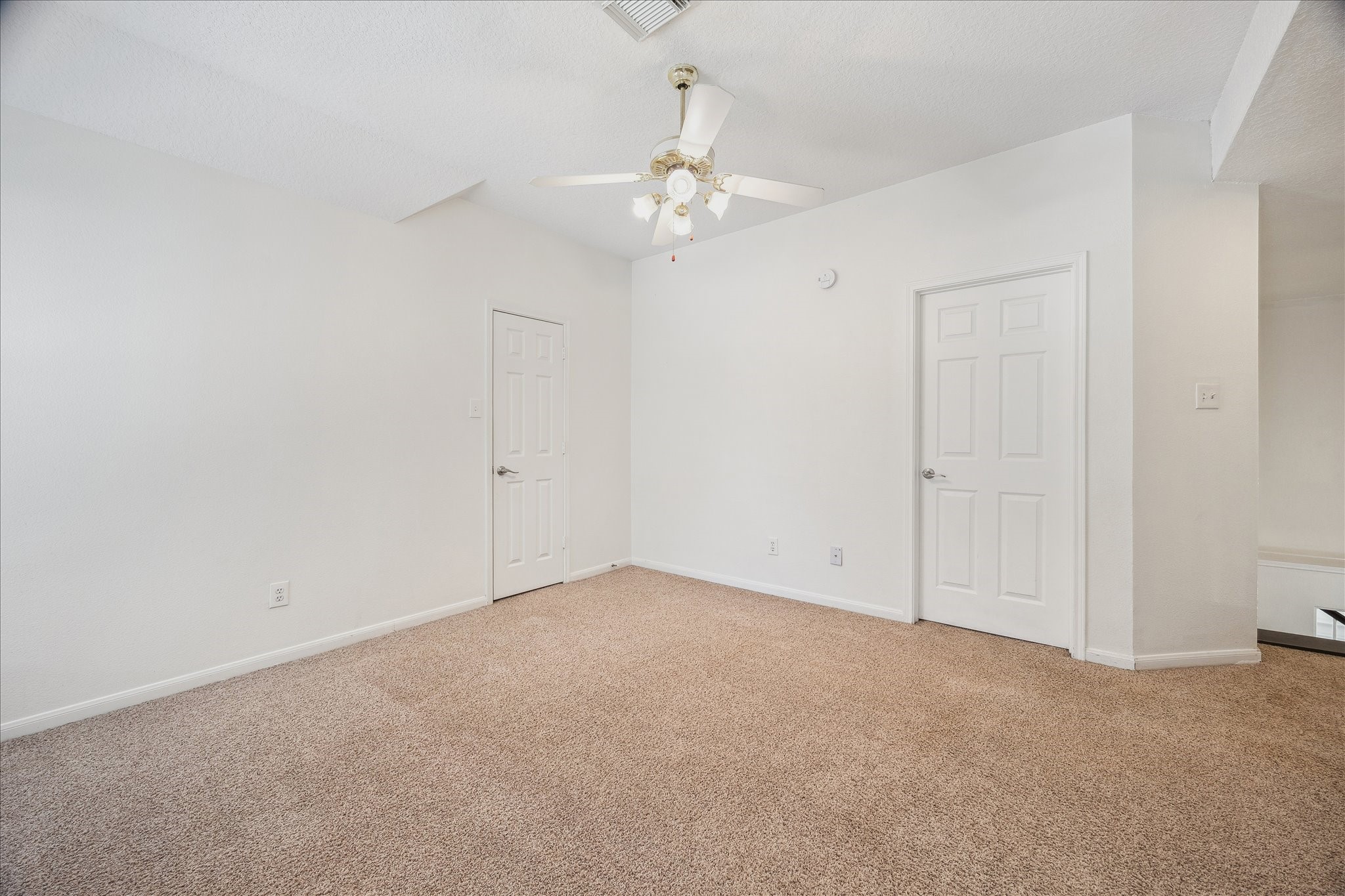 12831 Dove Point Lane Houston, TX 77041 - Photo 43 of 49 an empty room with a chandelier fan and closet