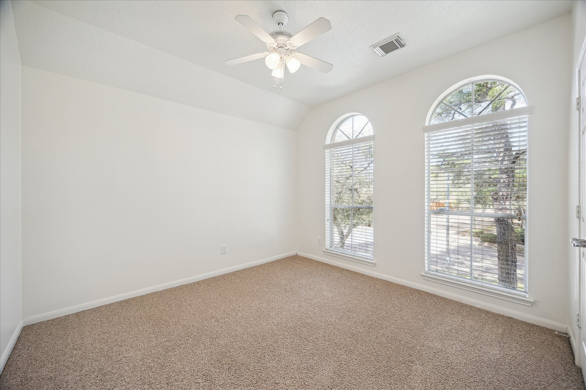 12831 Dove Point Lane Houston, TX 77041 - Photo 46 of 49 an empty room with a fan and windows
