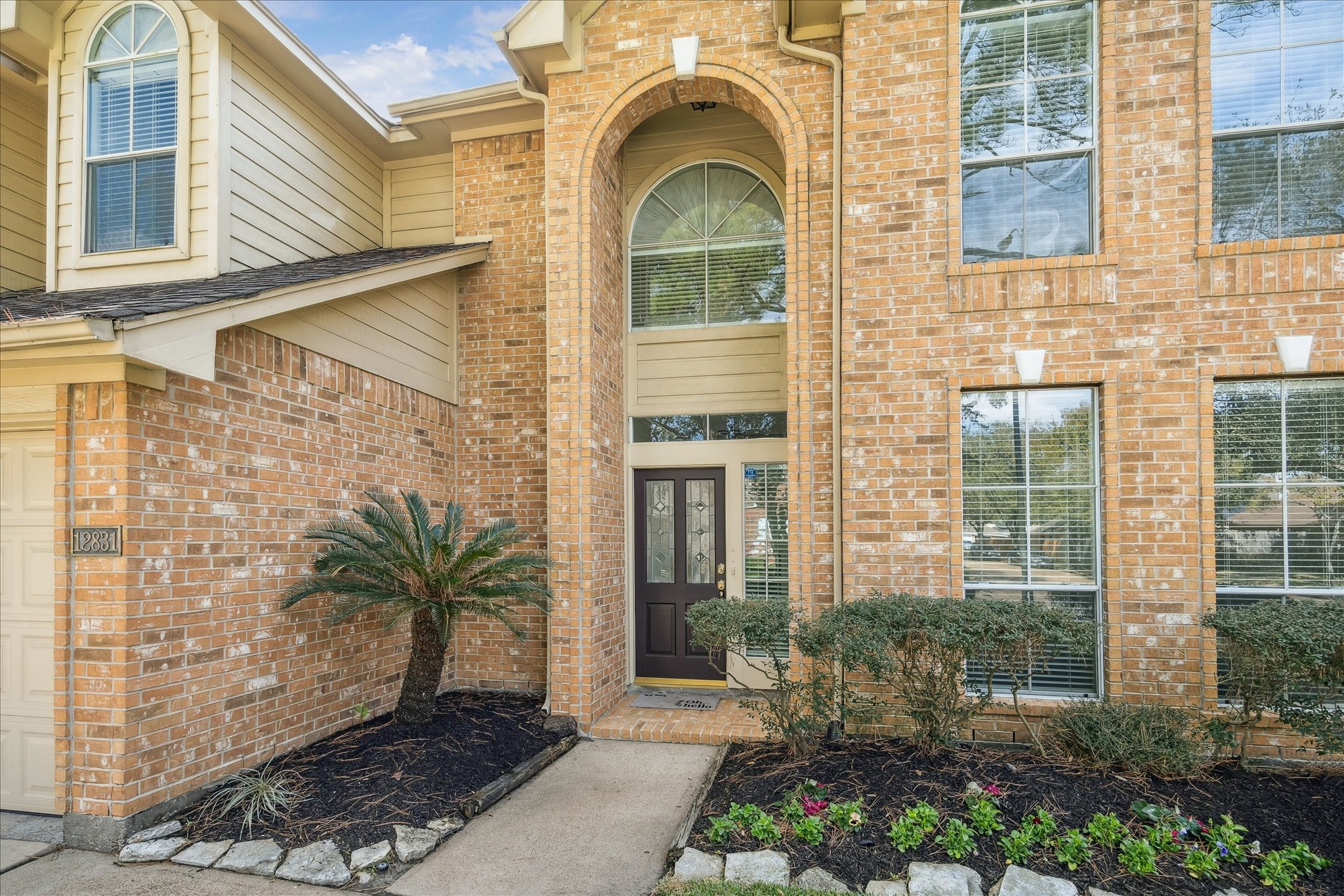 12831 Dove Point Lane Houston, TX 77041 - Photo 5 of 49 a front view of a house with a garden