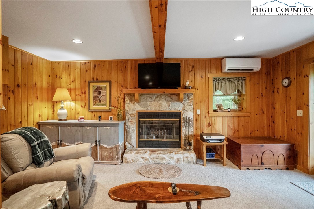 710 River Hills Road Lansing, NC 28643 - Photo 20 of 38 a living room with furniture a flat screen tv and a fireplace