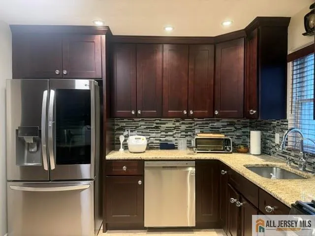 a kitchen with a sink cabinets and stainless steel appliances