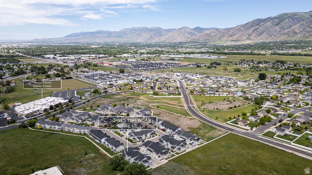 2483 South 1296th Street West Logan, UT 84321 - Photo 30 of 45 Aerial view showcasing a residential area with a prominent multi-story building featuring a large parking area