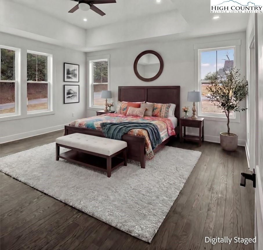 20 Busic Ridge Sparta, NC 28675 - Photo 11 of 50 a bedroom with a bed a dresser and potted plant with wooden floor