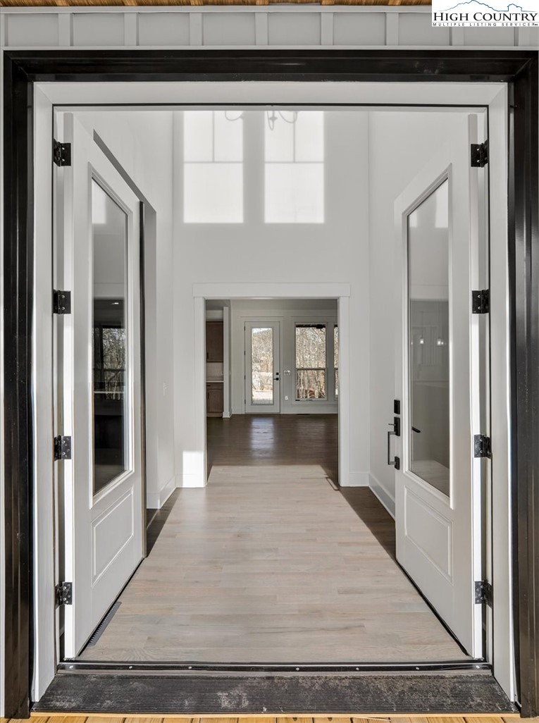 20 Busic Ridge Sparta, NC 28675 - Photo 17 of 50 a view of a hallway with wooden floor and a living room