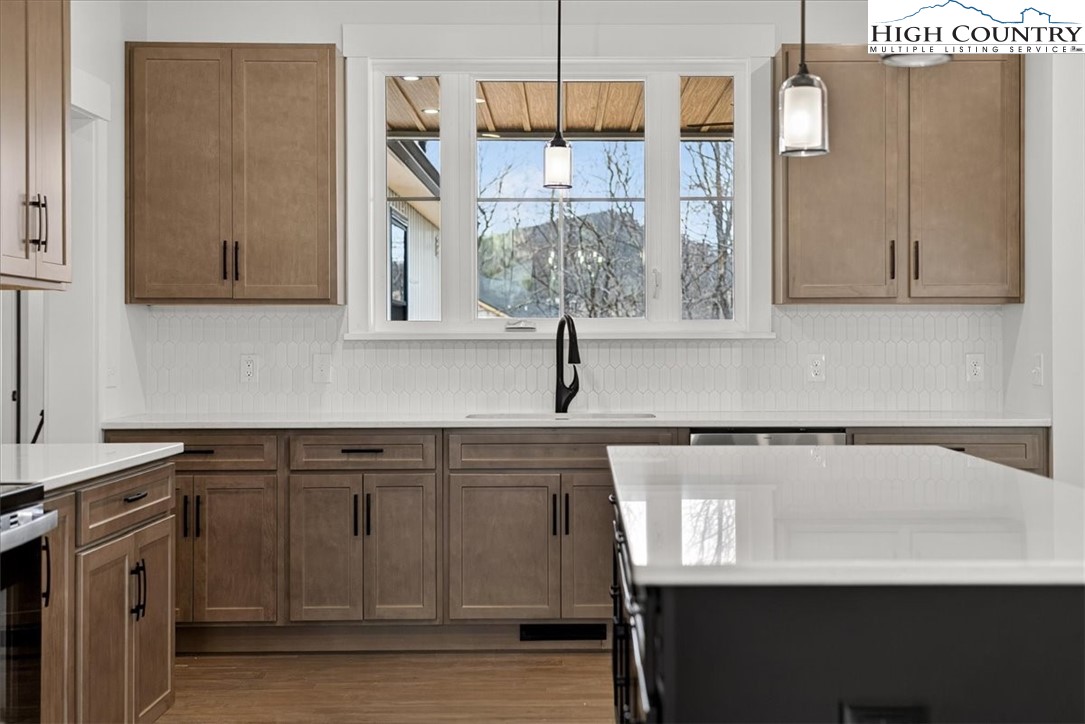 20 Busic Ridge Sparta, NC 28675 - Photo 22 of 50 a kitchen with stainless steel appliances granite countertop a sink a stove and a wooden floors