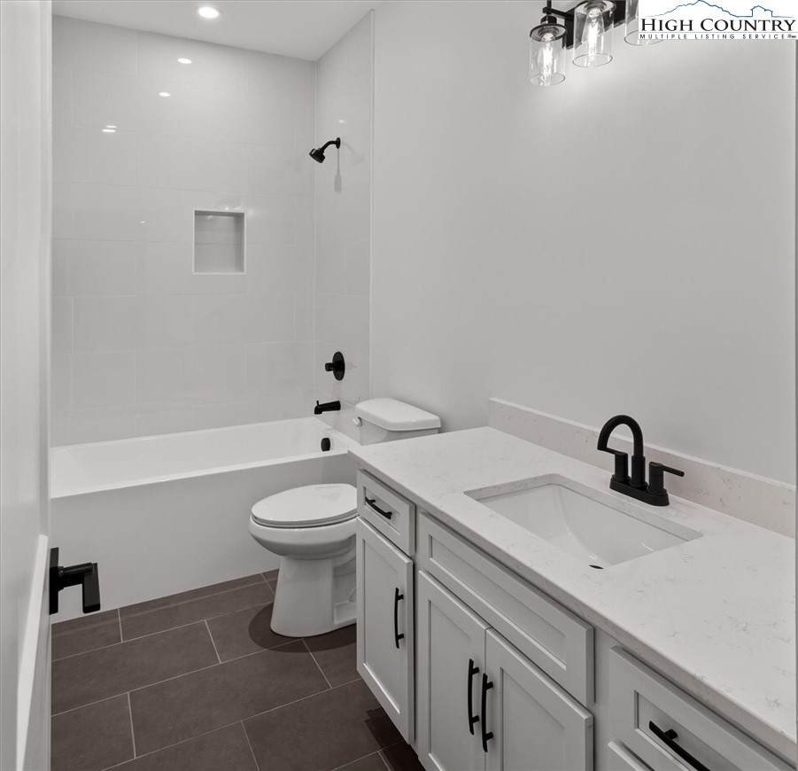 20 Busic Ridge Sparta, NC 28675 - Photo 31 of 50 a bathroom with a toilet a sink and mirror