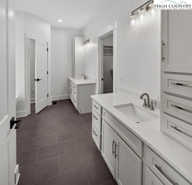 20 Busic Ridge Sparta, NC 28675 - Photo 37 of 50 a spacious bathroom with a double vanity sink mirror and toilet