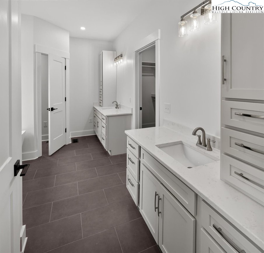 20 Busic Ridge Sparta, NC 28675 - Photo 37 of 50 a spacious bathroom with a double vanity sink mirror and toilet