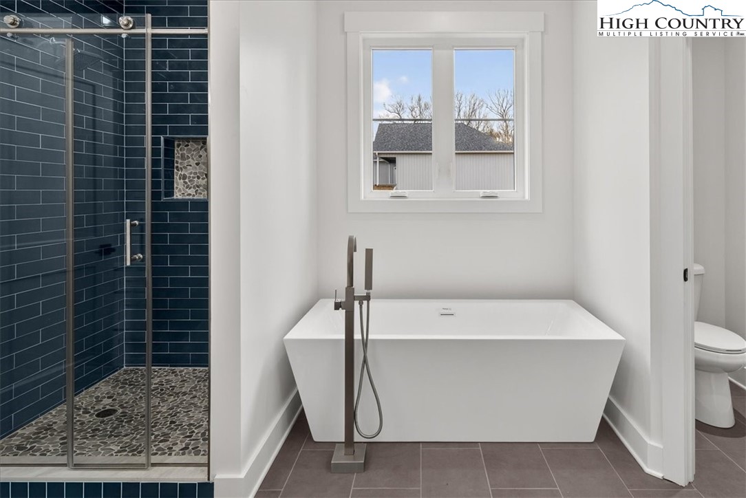 20 Busic Ridge Sparta, NC 28675 - Photo 39 of 50 a bathroom with a bathtub and a shower