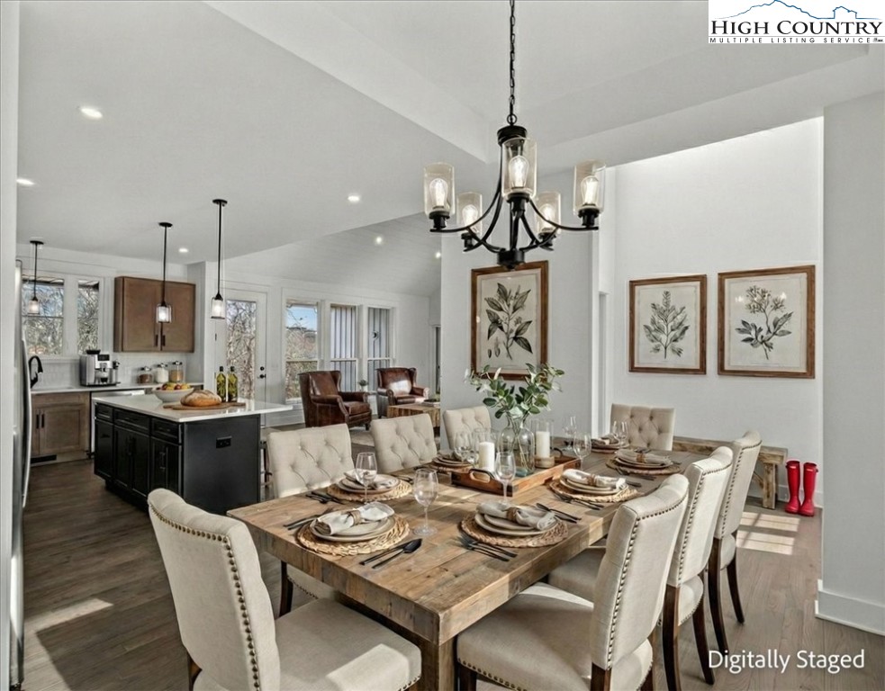 20 Busic Ridge Sparta, NC 28675 - Photo 6 of 50 a dining room with wooden floor a chandelier a wooden table and chairs