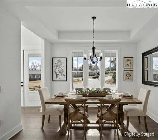 a kitchen with stainless steel appliances granite countertop a sink a stove and a wooden floors