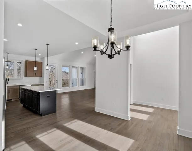 a kitchen with stainless steel appliances granite countertop a stove a refrigerator and a sink