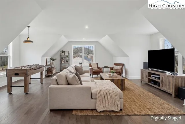a kitchen with stainless steel appliances granite countertop a sink a stove and a wooden floors