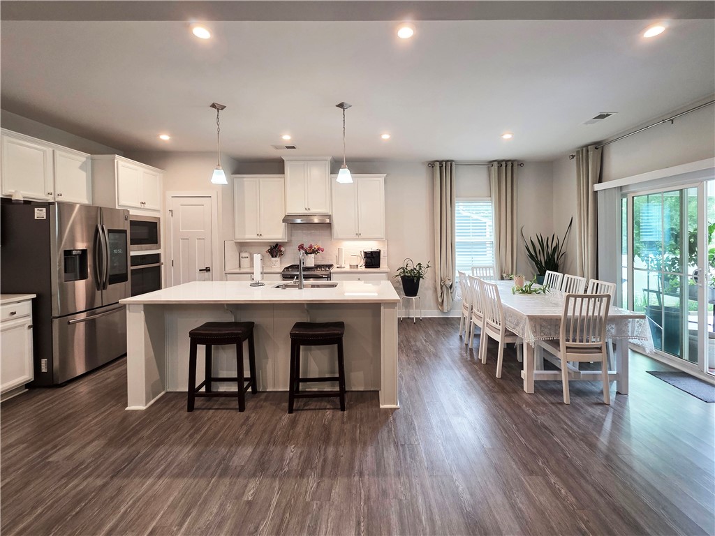 224 Bronson Ridge Anderson, SC 29621 - Photo 41 of 42 An open floorplan seamlessly connects the well-appointed kitchen to a bright dining area with sliding glass doors.