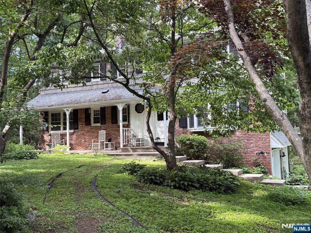 36 Lavina Trail Oak Ridge, NJ 07438 - Photo 1 of 26 a front view of a house with garden