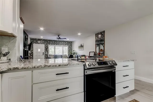 a kitchen with stainless steel appliances granite countertop a sink and cabinets