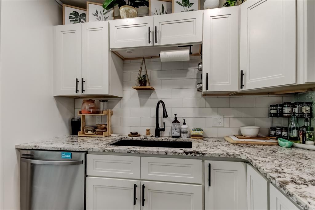 2170 Americus Boulevard North, Unit 64 Clearwater, FL 33763 - Photo 12 of 66 a kitchen with stainless steel appliances granite countertop a sink and cabinets