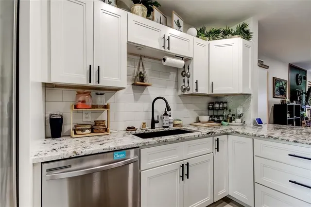 a kitchen with stainless steel appliances a refrigerator sink and cabinets
