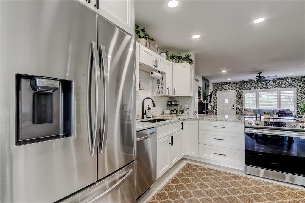 2170 Americus Boulevard North, Unit 64 Clearwater, FL 33763 - Photo 14 of 66 a kitchen with stainless steel appliances a refrigerator sink and cabinets