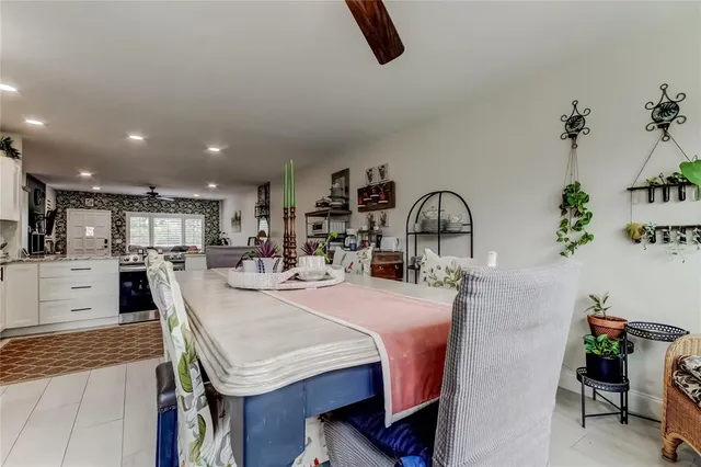 a living room with furniture a flat screen tv and a window