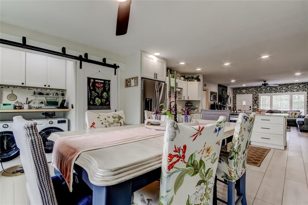 2170 Americus Boulevard North, Unit 64 Clearwater, FL 33763 - Photo 20 of 66 a kitchen with stainless steel appliances kitchen island granite countertop a dining table chairs sink refrigerator and microwave