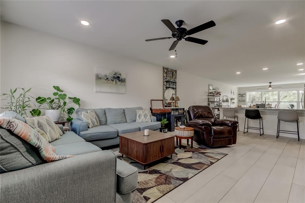 2170 Americus Boulevard North, Unit 64 Clearwater, FL 33763 - Photo 2 of 66 a living room with furniture ceiling fan and a rug