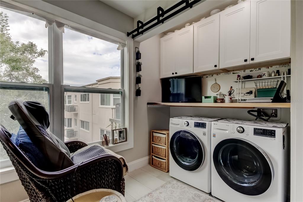 2170 Americus Boulevard North, Unit 64 Clearwater, FL 33763 - Photo 21 of 66 a living room with furniture a flat screen tv and a window