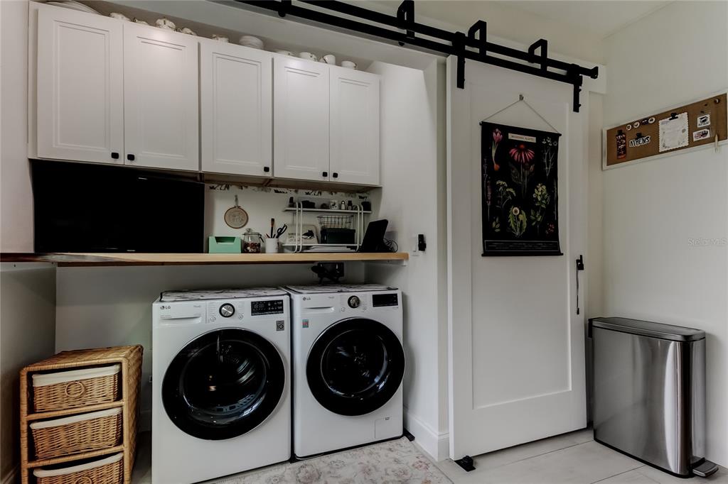 2170 Americus Boulevard North, Unit 64 Clearwater, FL 33763 - Photo 22 of 66 a view of a storage and utility room with washer and dryer