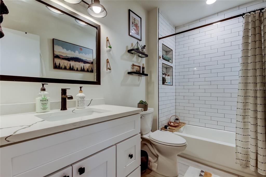 2170 Americus Boulevard North, Unit 64 Clearwater, FL 33763 - Photo 23 of 66 a bathroom with a sink a toilet and shower