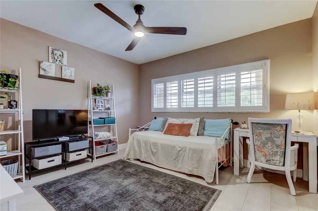 2170 Americus Boulevard North, Unit 64 Clearwater, FL 33763 - Photo 25 of 66 a bedroom with a bed and a flat screen tv