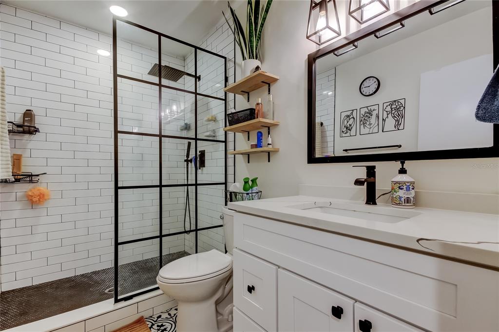 2170 Americus Boulevard North, Unit 64 Clearwater, FL 33763 - Photo 30 of 66 a bathroom with a sink a toilet and a shower