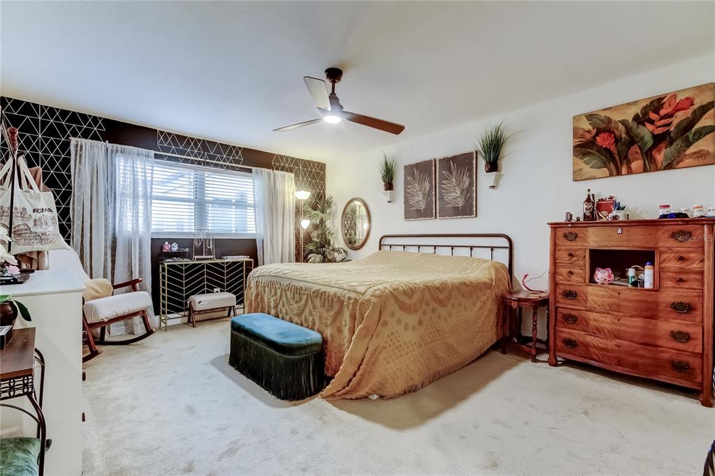 2170 Americus Boulevard North, Unit 64 Clearwater, FL 33763 - Photo 32 of 66 a spacious bedroom with a bed and a large window