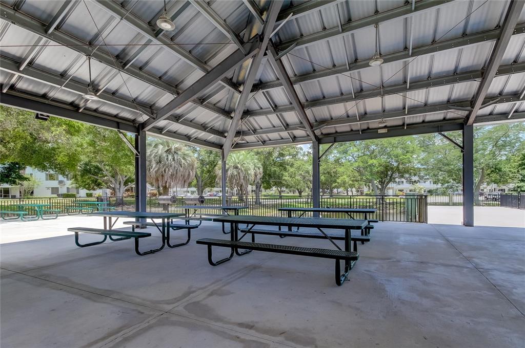 2170 Americus Boulevard North, Unit 64 Clearwater, FL 33763 - Photo 50 of 66 a view of a swimming pool with outdoor seating